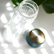 glass bottle with a blue cap 